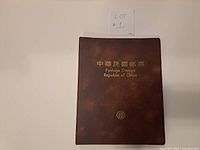 Front cover of brown binder with gold title text