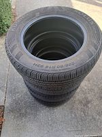 Stack of four Kumho tires showing tread and sidewalls