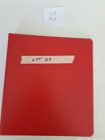 Closed red binder with lot identifier
