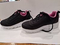 Side view of both sneakers showing colour scheme and soles