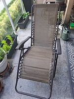 Full view of folded-out zero-gravity chair on patio