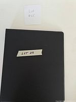 Closed black binder containing the card collection
