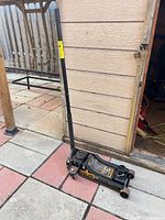 Full view of floor jack with handle attached