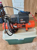 Full view of orange Pro Air II compressor on tote