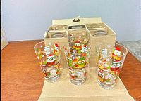 Owl print tumblers in front of cardboard holder