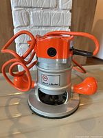 Front view of the Black & Decker corded router showing brand badge, cord, base and housing