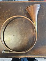 Circular hunting horn laid on tabletop