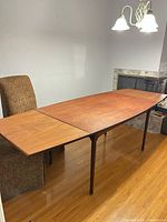 Dining table fully extended with both leaves installed