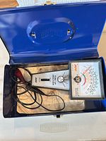 Tester and leads inside open blue metal case