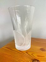 Full view of clear glass vase showing frosted swirl and tapered shape