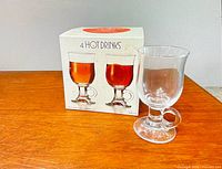 Box labeled '4 Hot Drinks' beside one sample glass