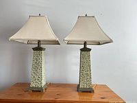 Front view of both matching table lamps with shades showing bases, shades, finials, cords