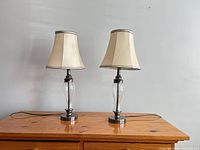 Front view of both matching table lamps showing shades, stems, and bases