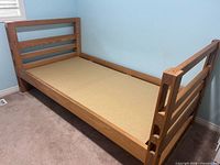 overall view of wooden single bed frame without mattress