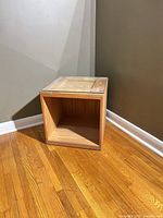 cube side table front angle showing open cavity and glass top