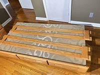 wooden trundle frame with mattress and four slats