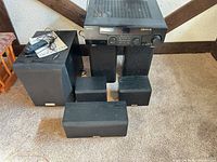 Receiver resting on speakers and all six speakers arranged