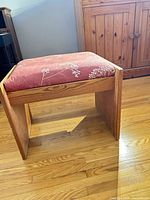 Overall view of wooden stool showing cushion and wood frame