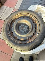 Tire mounted on steel rim showing overall condition