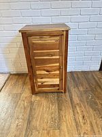 Front view of small wooden cabinet closed