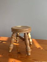 Front angle of small wooden stool on table