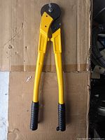 Full view of 18-inch yellow cable cutters on cardboard background