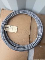 Full view of coiled steel wire rope on cardboard