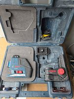 Open case showing laser level, WM1 mount, base plate and case interior