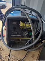 Front view of Clarke Hot Shot 135SG welder showing control panel and cables