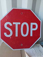 Front view of red reflective stop sign showing lettering and wear