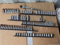 Full view of ratchet with multiple rails of assorted sockets