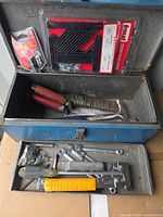 Overall view of blue metal toolbox open with tray and contents visible