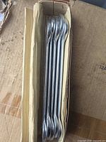 Stack of five wrenches in cardboard sleeve