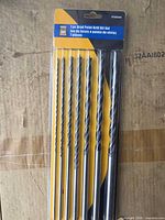 Front view of sealed 7-piece Power Fist brad point drill bit set in packaging