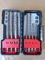 Case open showing seven Bosch SDS-Plus rotary hammer drill bits