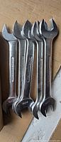 Five identical Britool open-end metric wrenches stacked