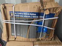 Front of boxed Power Fist 2-pc 2000 lb vehicle dollies, full package view