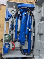 Entire kit in case showing pump, ram, hose, extensions