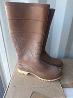 Side view of both brown rubber boots showing OnGuard logo and overall condition