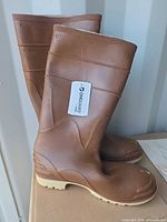 Pair of brown Onguard rubber boots side view with tag