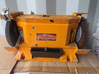 Full view of grinder showing both wheels and housing