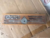 Closed wooden case showing Super Quality marking and contents outline