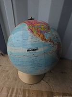 Full view of Maclean's globe on base