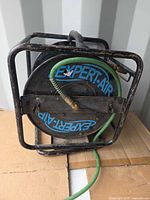 Front view of Expert-Air reel in metal cage with hose attached