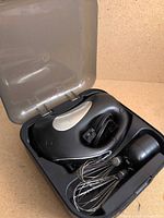 Mixer stored inside open carrying case showing interior layout