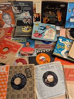 Overview of mixed 45s with sleeves showing labels and titles
