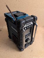 Front view of Makita jobsite radio showing display, controls and chrome handles