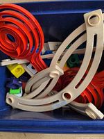 overview of various marble run pieces in blue tote