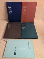 Five music books: four cloth hardcovers Nos.1-4 and one blue stapled hymns booklet