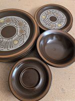 Stack of dinner plates, side plates and bowls showing overall quantity and colour